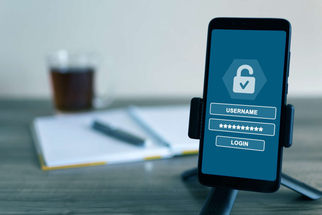 A username and password for login on the screen of a cell phone - cybersecurity concept