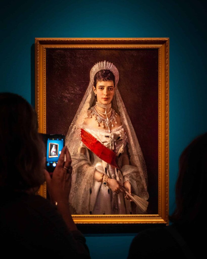 Tourist photographing artwork inside a museum